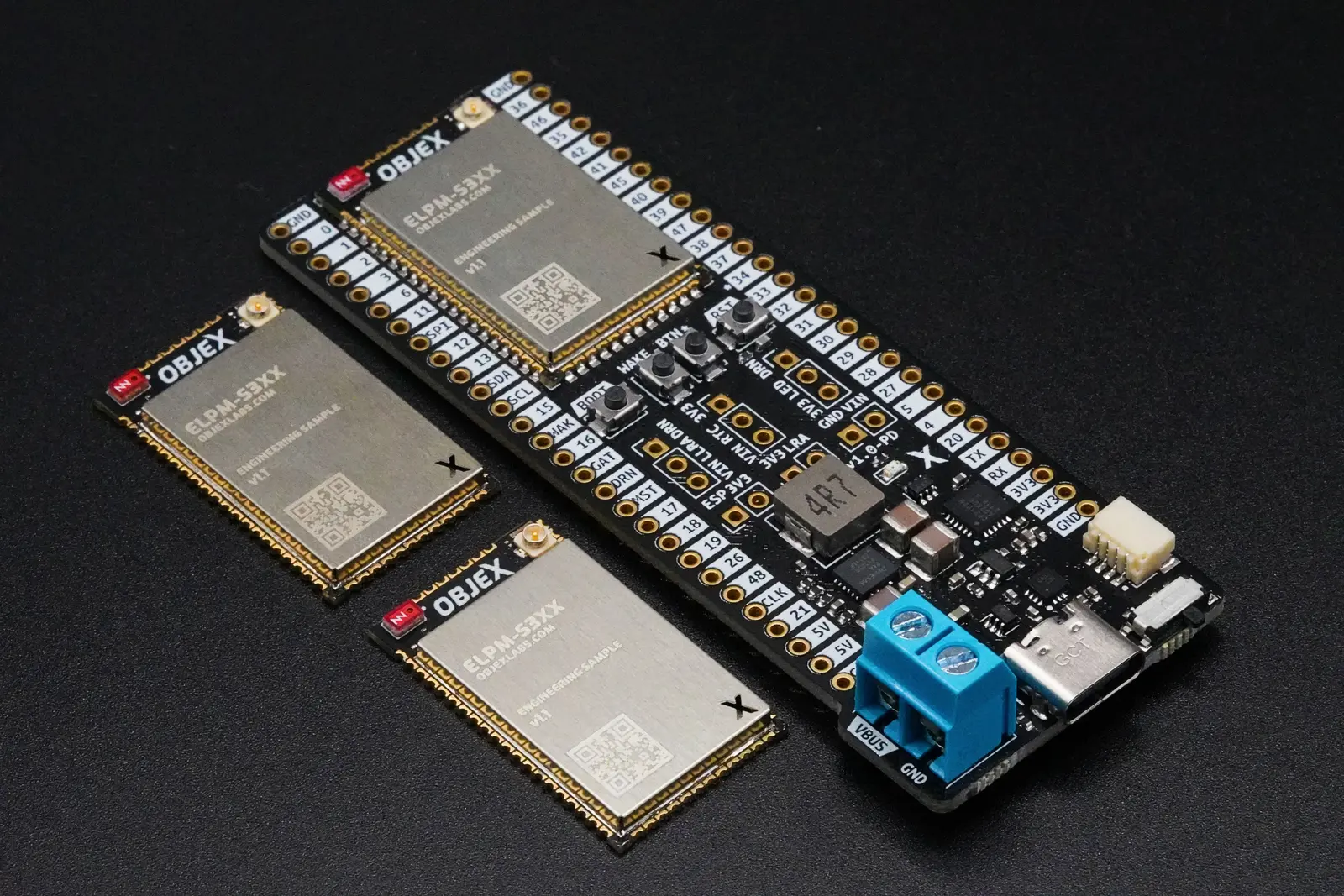 OBJEX Link development board beside two bare ELPM modules on a black surface