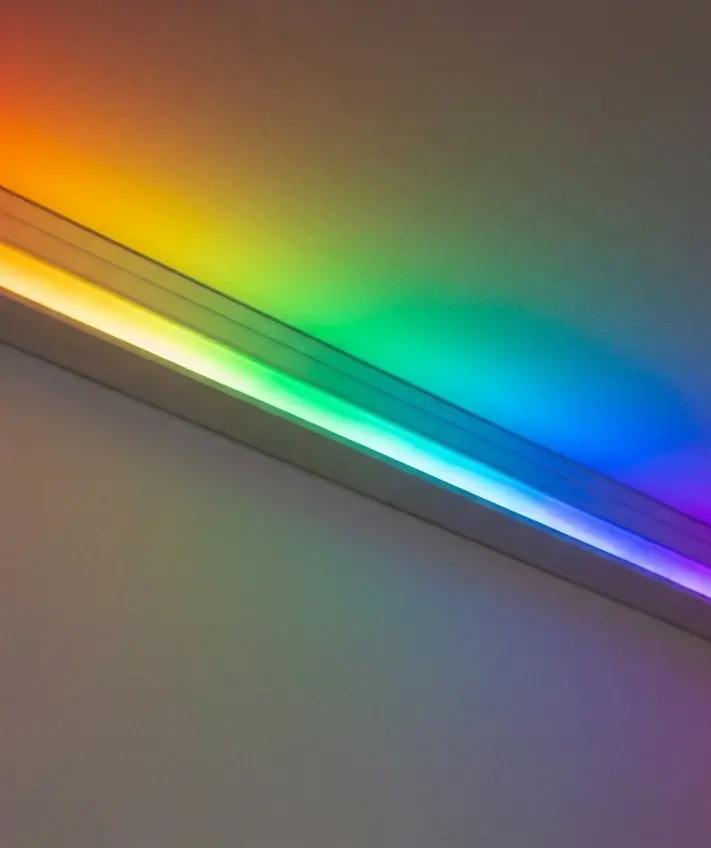 An addressable LED strip running a rainbow gradient in a ceiling profile
