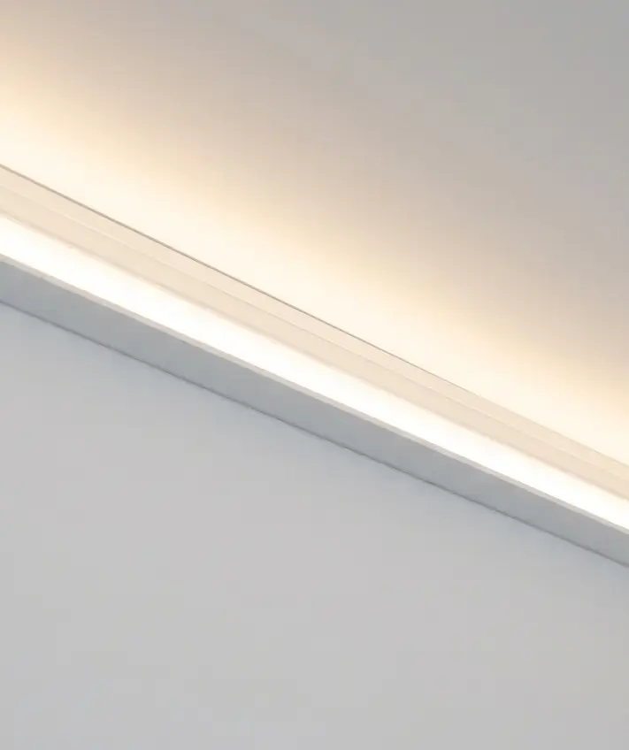A warm-white LED strip glowing in a ceiling cove